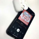 Regretting You by Colleen Hoover Audiobook Cover next to AirPods